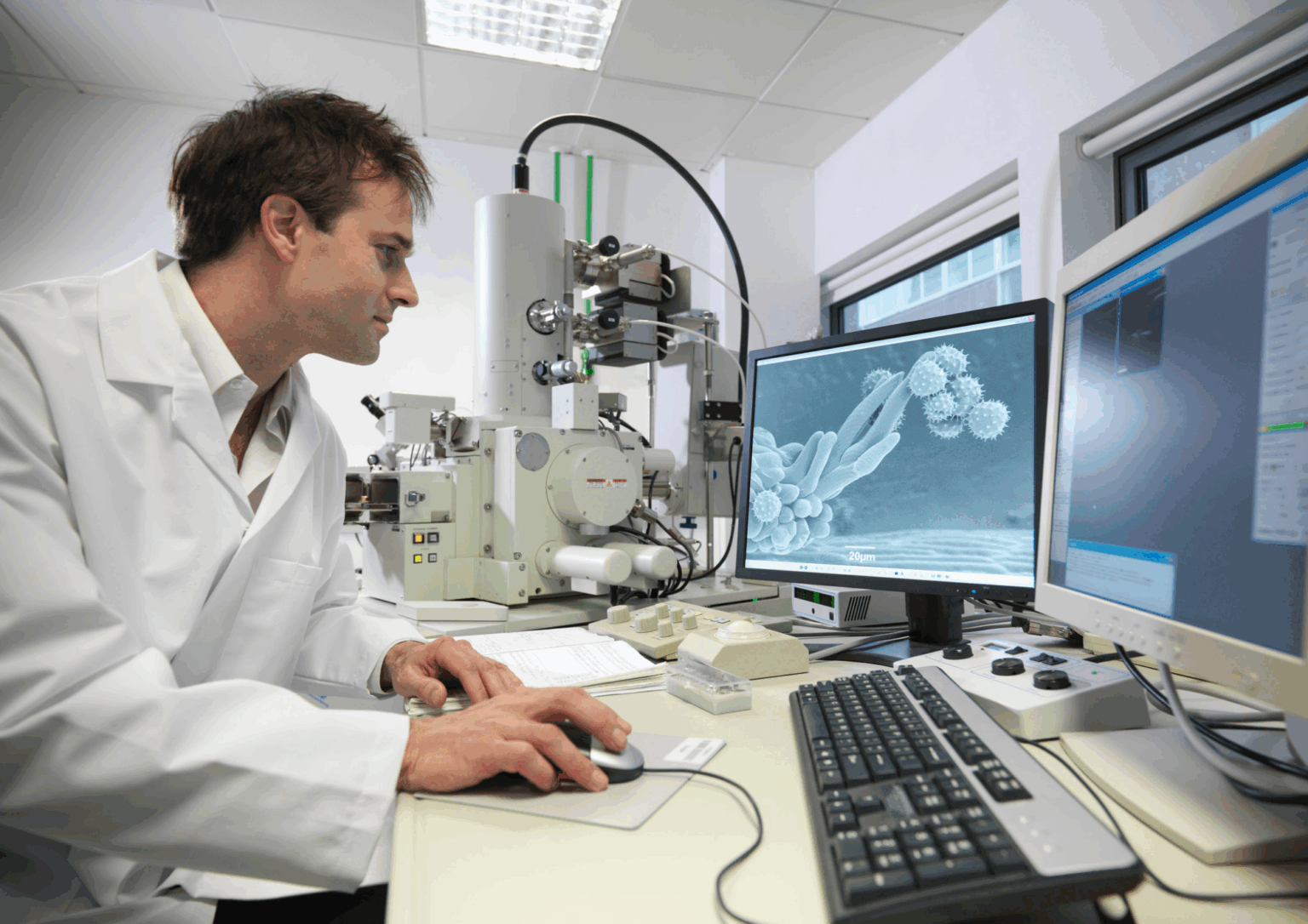 ATAR Physics scientist analysing microscopic images in laboratory.